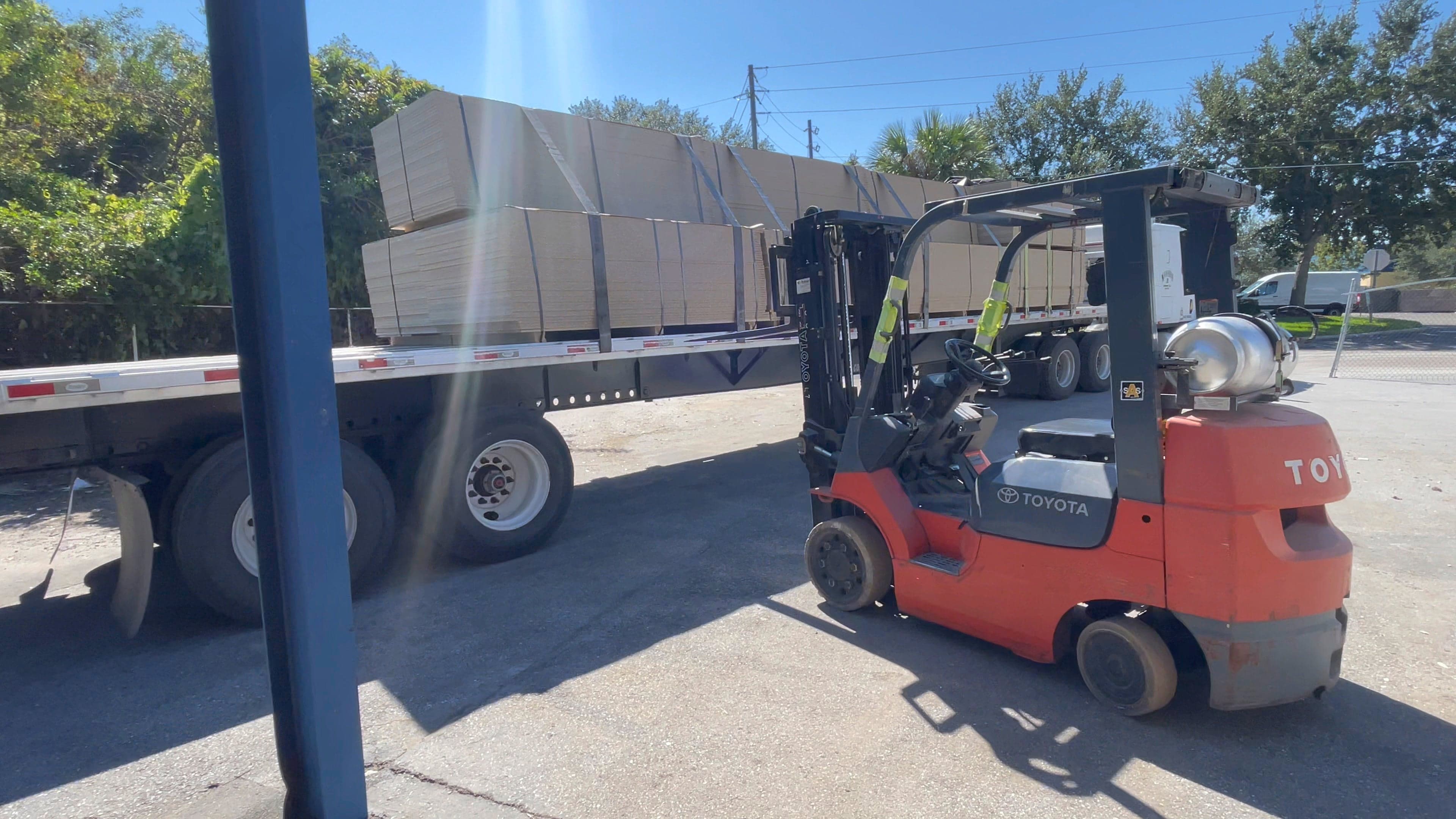 A delivery of cabinet materials arriving at the Quality Arcades workshop