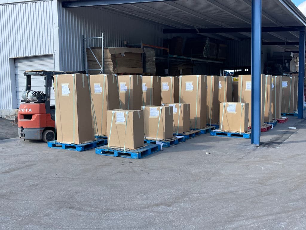 Finished arcade cabinets wrapped and secured on shipping pallets